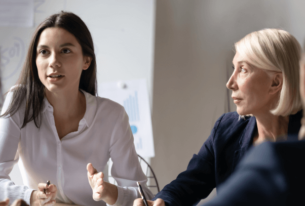 A new employee speaking to a group of executives